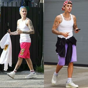 Justin Bieber shows off toned and tattooed arms in clinging tank top as he struts his stuff out in New York