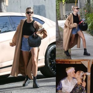 Hailey Bieber shows off her toned physique in cool denim and a crop top as she meets her friends for lunch in Beverly Hills