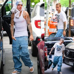 Justin Bieber wraps shirt around his HEAD as he showcases toned physique in clinging tank top in NYC