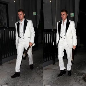 Justin Bieber looks uncharacteristically dapper as he sports white three-piece tuxedo with a cane for dinner in LA